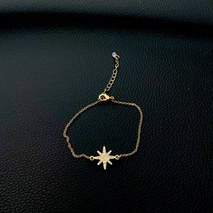 10 karat gold plated over surgical steel with crystals in the star.